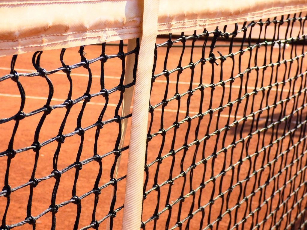 Court de tennis en terre battue avec filet, ambiance Flushing Meadows US Open
